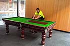 Experienced removalists delicately handling a pool table during the relocation process